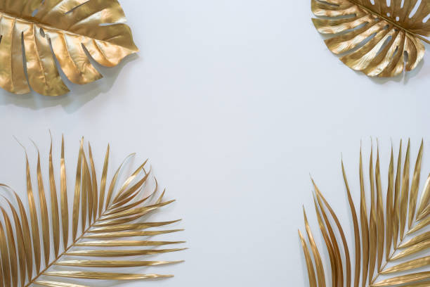 istock Gold tropical palm leaves Monstera on white background. Flat lay, 1298294755