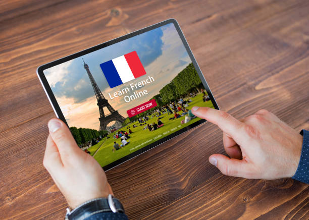 istock Person taking online courses on tablet to learn French language 1298294924