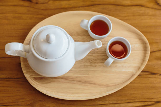 istock A teapot and tea cups on wooden table, Tea ceremony concept 1298295004