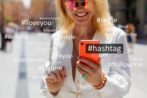 Woman using social media; concept of hashtag usage on social media platforms