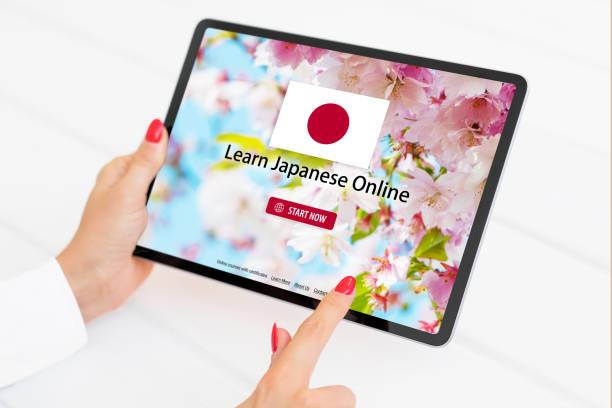 istock Person taking online courses on tablet to learn Japanese language 1298295122