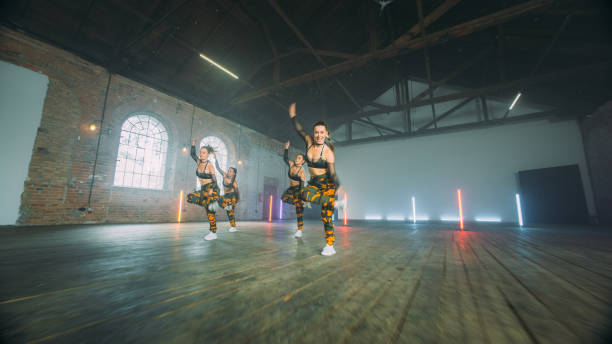 istock Female dancers practicing in studio. Modern moves, camo outfits 1298297638