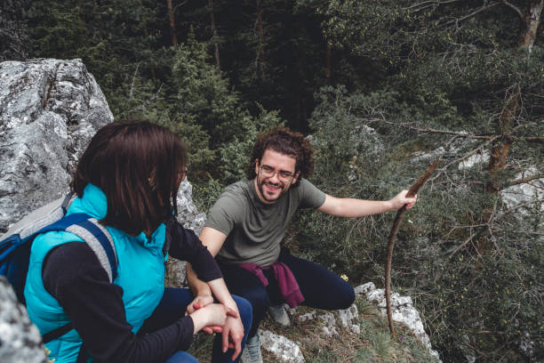 istock Couple taking a break while mountaineering, sitting and relaxing at a viewpoint 1298300018