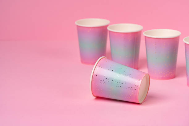 istock Pink disposable paper cups on pink background 1298300832