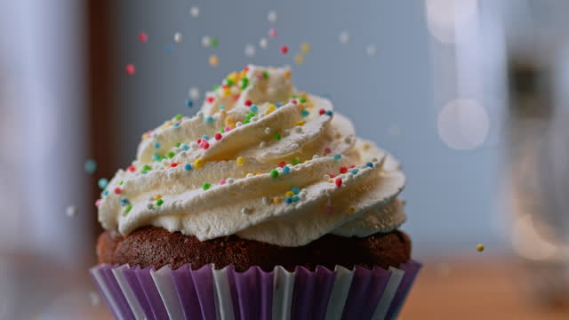 SLO MO Sprinkles falling onto a cupcake