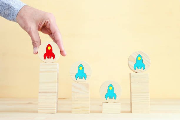istock rocket leadership concept. male hand picking the leader 1298305375