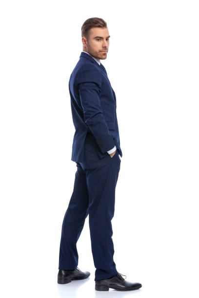 istock attractive elegant man in navy blue suit looking over shoulders 1298306373