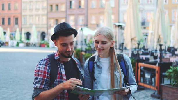 istock Tourists checking map and then smiling to the camera 1298309642