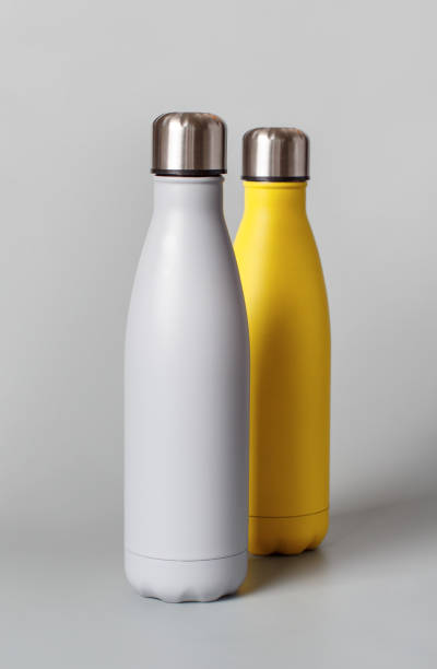 istock Grey and yellow reusable bottles on grey background 1298312777