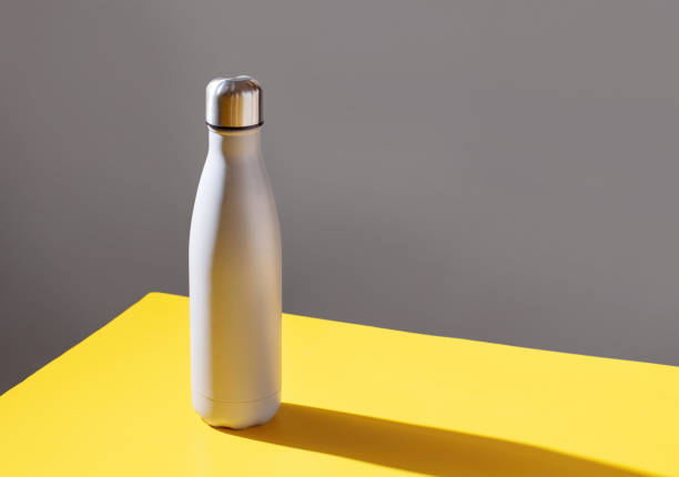 istock Grey insulated bottle on grey and yellow background 1298312785