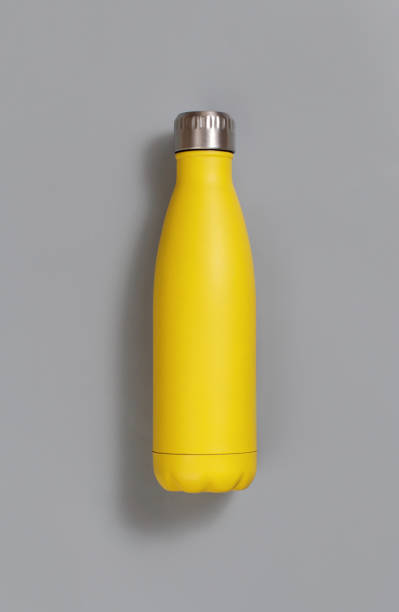 istock Yellow reusable insulated bottle on yellow background 1298312807