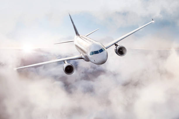 istock Airplane flying through the air above the clouds 1298314090