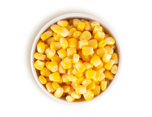 istock Canned corn in white bowl isolated on white background, top view 1298314642