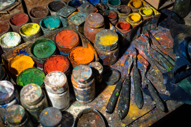 istock Acrylic paint cans and knives on the table 1298314972