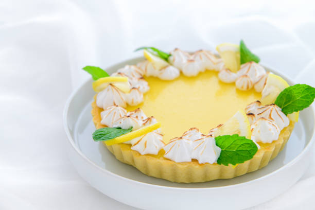 istock Lemon Tart citrus cake in white dish and white cloth background, 1298315192