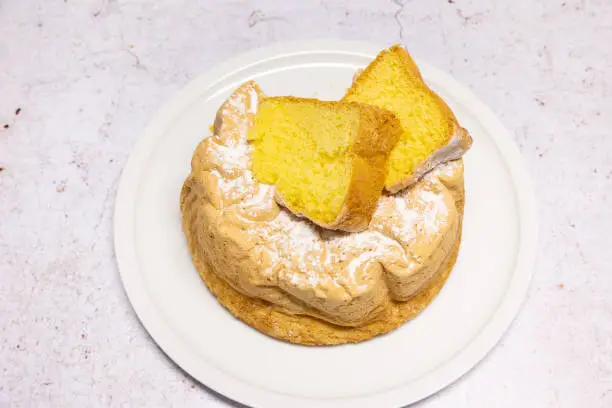 Homemade Savoie cake on a pretty white porcelain dish.