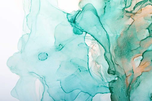 Watercolor alcohol ink swirls. Transparent waves in turquoise green colors. Delicate pastel spots.