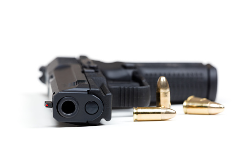 9mm pistol bullets and handgun on white background