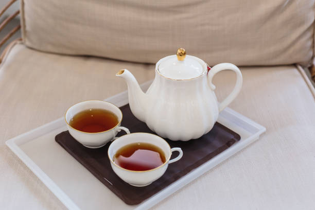 A teapot and tea cups on sofa at home, Tea ceremony concept