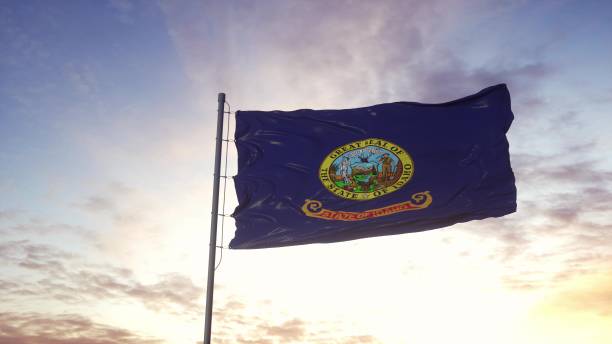 State flag of Idaho waving in the wind. Dramatic sky background. 3d illustration