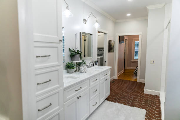istock Large white renovated master bathroom with red brick floors 1298320836