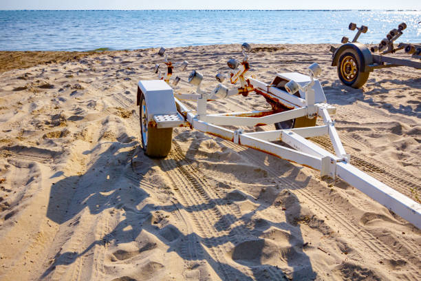 istock Trailer for transport boats on the sandy beach 1298321969