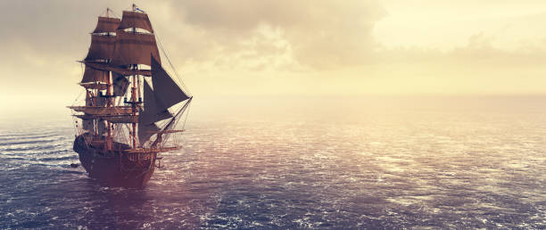istock Pirate ship sailing on the ocean at sunset 1298322587