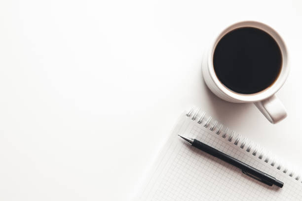 istock Office desk table with supplies, coffee cup and flower. Top view 1298324431