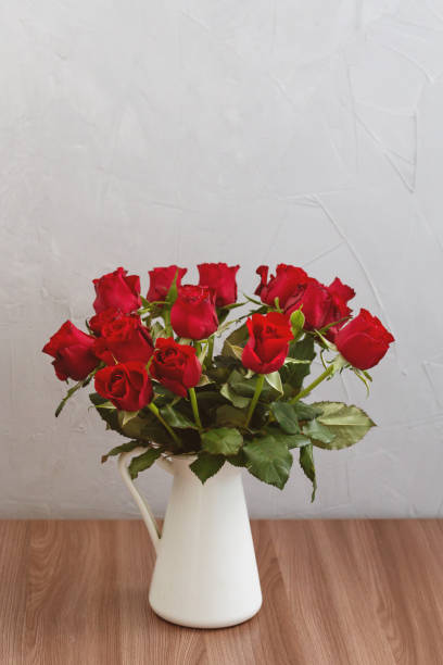 istock bouquet of red roses in vase, greeting card template with empty space for text 1298324867