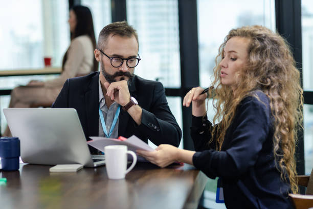 istock Young manager listening to his colleague explanations in modern co working office. 1298326510