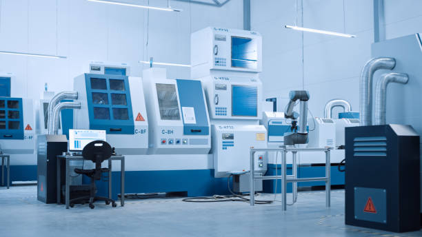 istock Industry 4.0 Modern Factory: AI Optimized and Automated High-Tech Contemporary Industrial Electronics Manufacturing Plant with CNC Machines and Working on Assembly Line Robot Hand. 1298326731