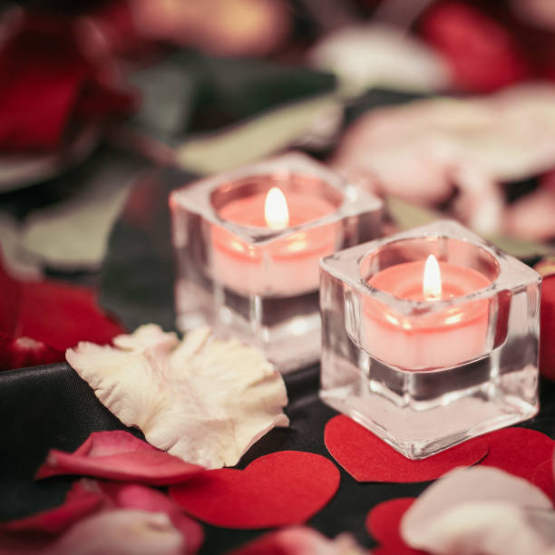 istock two candles and a ring on a festive background 1298327806