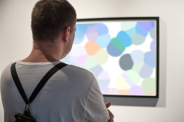 istock Young man in modern art exhibition gallery hall 1298328650