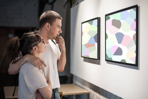 Young couple in modern art exhibition gallery hall