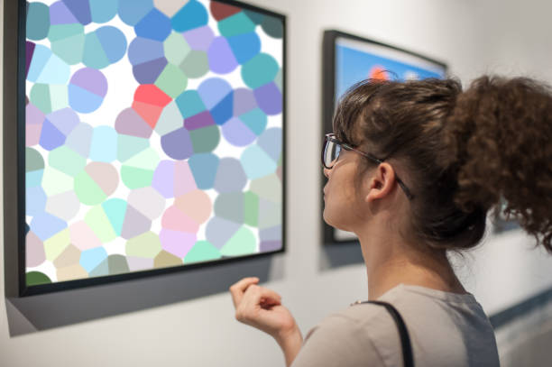 istock Young woman in modern art exhibition gallery hall 1298329558