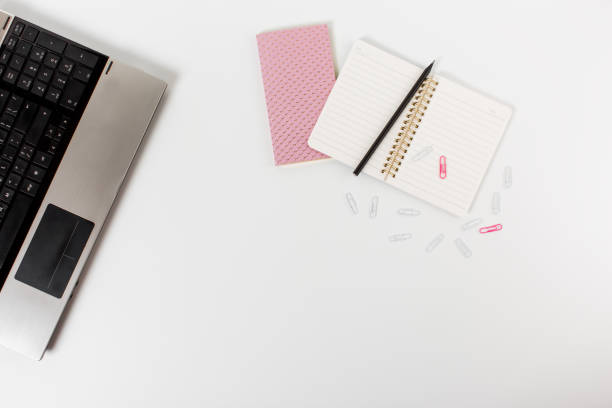 istock Flat lay home office desk. Mockup with notepad, notebook, paper clips and pencil on white background. 1298329591