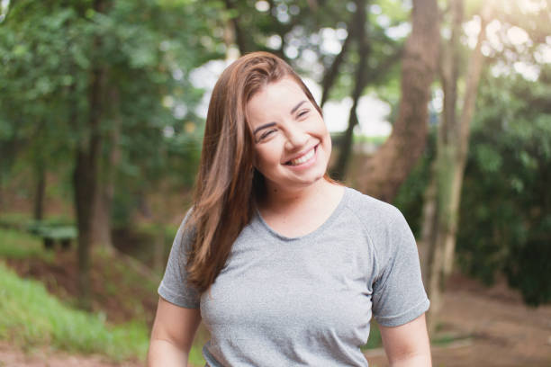 istock Beautiful young woman on the park 1298329685
