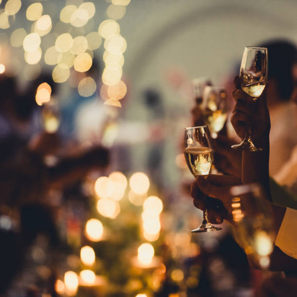 celebratory toast with string lights and champagne silhouettes square - political party concepts glamour friendship imagens e fotografias de stock