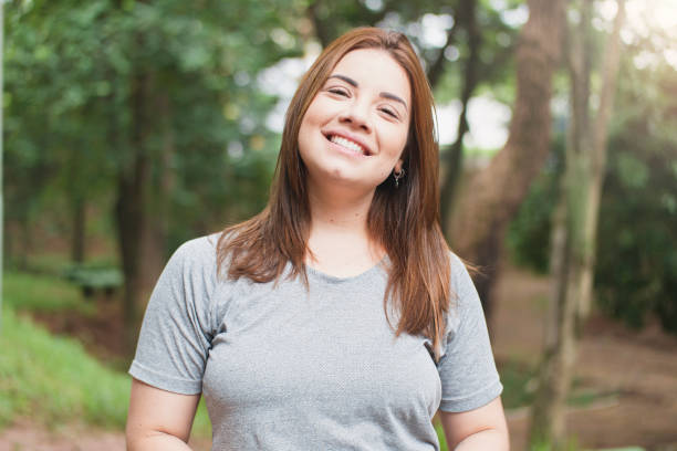 istock Beautiful young woman on the park 1298329754