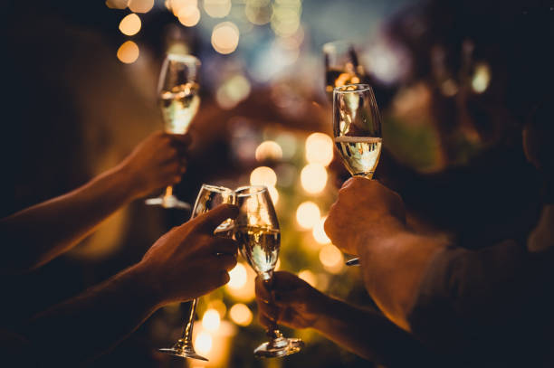 party celebratory toast with string lights and champagne silhouettes - political party concepts glamour friendship imagens e fotografias de stock