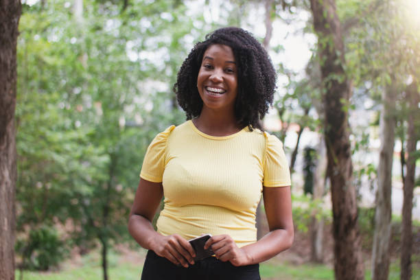 istock Beautiful young woman on the park 1298329900