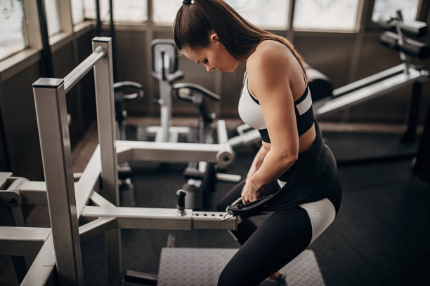 istock Fit woman training on exercise machine in gym 1298329974