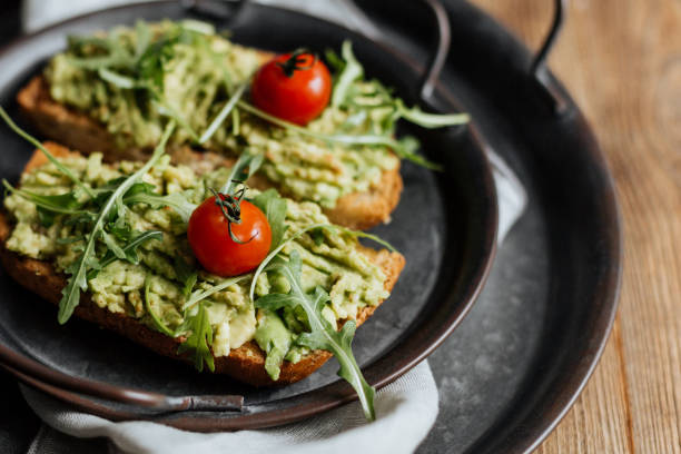 istock Toast with avocado, arugula and cherry tomatoes 1298331140