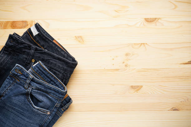 istock Jeans on a wooden background place for text, top view. 1298333053