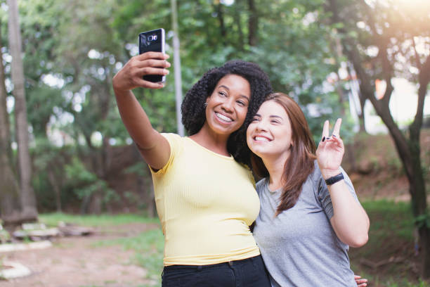 istock Young friends on the park taking a self portrait. 1298333073