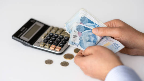 The man is counting Turkish Lira. The man is counting Turkish Lira. counting instrument stock pictures, royalty-free photos & images