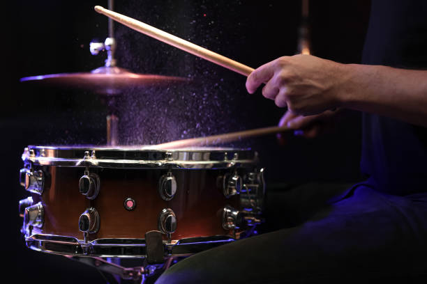 istock Drummer playing snare drum with sticks close up. 1298335908