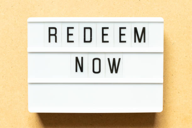 istock Lightbox with word redeem now on wood background 1298336611