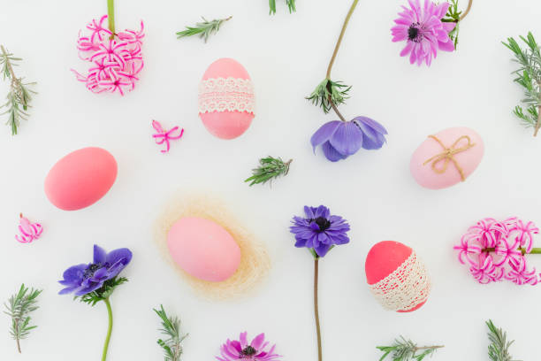 istock Ester holiday composition with colorful eggs, spring flowers, hypericum and leaves of lavender on white. Flat lay, top view 1298337933