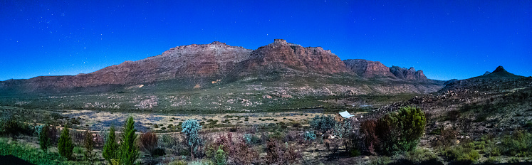 Panorama long exposure Kromrivier Cederberg Mountain range with mountain cabin at night Kromrivier Cederberg Wilderness Area Western Cape South Africa